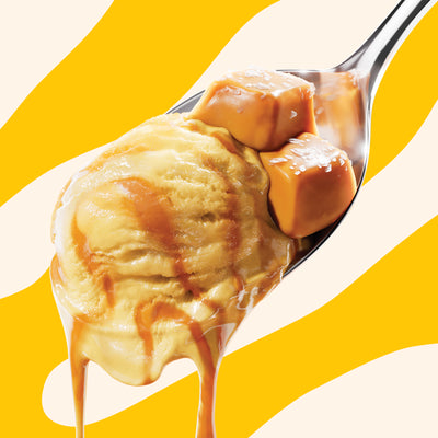 Pint of N!CK'S Sea Salt Caramel light ice cream. The label highlights 'no added sugar' and '310 calories/pint'. A spoon holds a scoop of caramel ice cream with a sea salt caramel swirl and pieces.